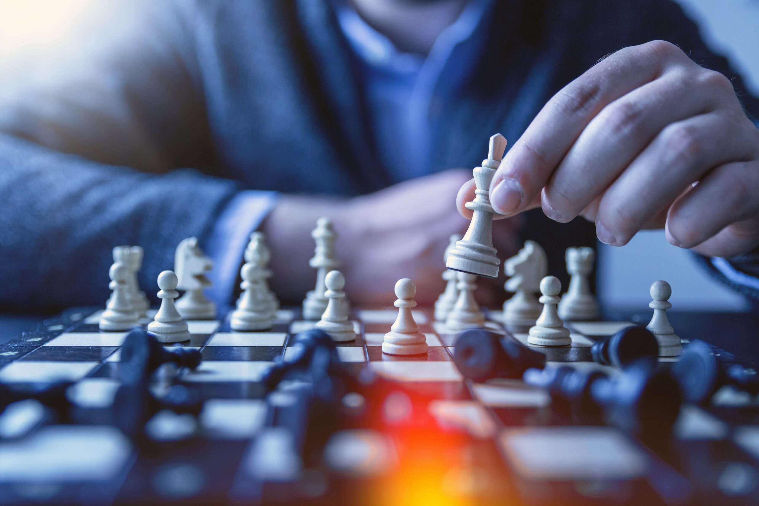 man sitting behind a chessboard